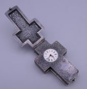 A 19th century unmarked white metal cross form pendant watch. 8 cm high.