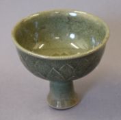 A Chinese celadon porcelain stem cup. 11 cm high.