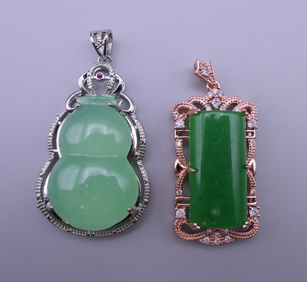 Two jade pendants. The largest 5.5 cm high.