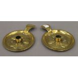 A pair of Victorian Arts and Crafts brass chambersticks. 16 cm diameter.