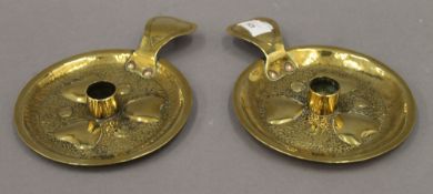 A pair of Victorian Arts and Crafts brass chambersticks. 16 cm diameter.