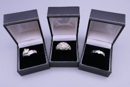 Three silver dress rings.