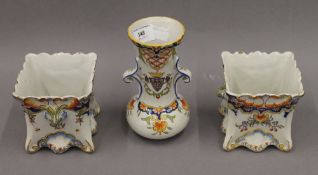 A pair of matching faience jardinieres and a faience vase. The latter 15 cm high.