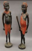 A pair of carved wooden figures of Maasai Tribe people. Each 90 cm high.