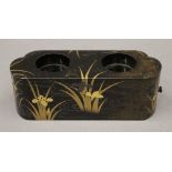 A Japanese Meiji Period lacquered travelling wine cup rest and five white metal wine cups.