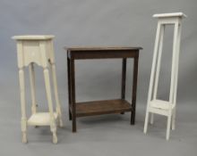 An early 20th century oak side table and two white painted plant stands. The former 59.5 cm long.