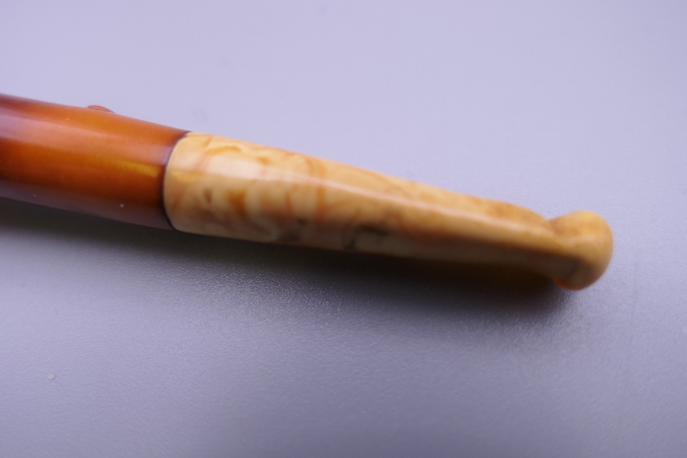 A cased 19th century meerschaum and amber pipe formed as a hand holding a pistol. 12 cm long. - Image 6 of 13