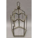 A brass hanging lantern, lacking glass. 63 cm high.