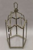 A brass hanging lantern, lacking glass. 63 cm high.