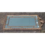 A 20th century gilt framed wall glass/mirror. 52.5 x 94 cm.