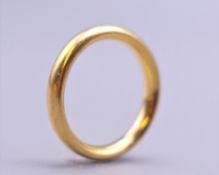 A 22 ct gold wedding band. Ring size L. 7.2 grammes.