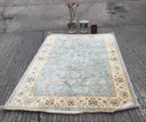 A modern rug and three decorative vases. The rug 160 x 230 cm.