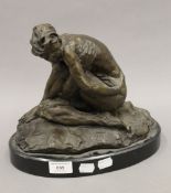 A bronze model of a kneeling woman. 25 cm high.