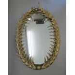 A reproduction faux antler framed mirror. 107 cm high.