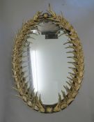 A reproduction faux antler framed mirror. 107 cm high.