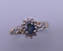 A 9 ct gold sapphire and diamond ring. Ring size L.