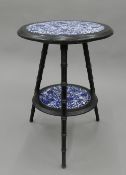 A Victorian aesthetic porcelain inset two-tier side table in the Liberty & Co style. 52 cm high.