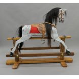 A 20th century painted wooden child's rocking horse. 137 cm long.