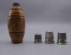 Three vintage sterling silver thimbles and an Edwardian treen 'Piccadilly' needle case.