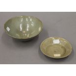 Two antique Chinese celadon pottery bowls. The largest 17 cm wide.