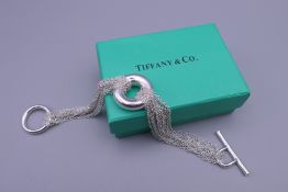 A silver bracelet in a Tiffany & Co box.