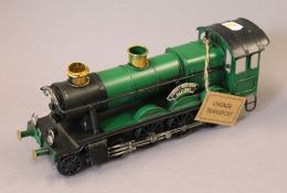 A green painted model of a locomotive. 30 cm long.