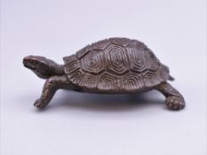 A bronze model of a tortoise. 5.5 cm long.