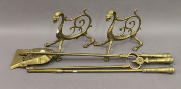 A set of brass fire irons and a pair of fire dogs