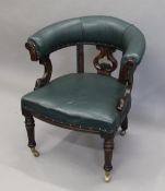 A leather upholstered Victorian oak tub chair. 71 cm wide.