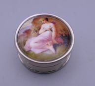 A silver circular pill box depicting a girl. 2.5 cm diameter.