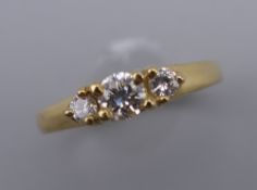 A vintage 18 ct gold diamond trilogy ring. Centre stone approximately 0.20 carat. Ring size K/L.