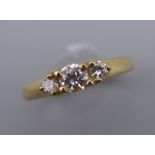 A vintage 18 ct gold diamond trilogy ring. Centre stone approximately 0.20 carat. Ring size K/L.