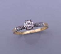 An 18 ct gold diamond solitaire ring. Ring size N.