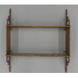 A Victorian oak hanging shelf. 46 cm wide.