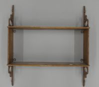 A Victorian oak hanging shelf. 46 cm wide.