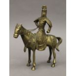 A brass model of a Mongolian warrior on horseback. 22.5 cm high.