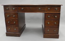 A Victorian mahogany three-piece pedestal desk. 118 cm wide.