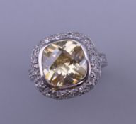 A silver, yellow and white cubic zirconia ring. Ring size L/M.