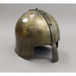 A brass re-enactment helmet. 22.5 cm high.