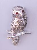 A silver marcasite owl brooch. 3 cm high.