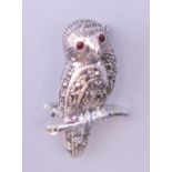 A silver marcasite owl brooch. 3 cm high.