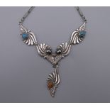 A vintage 925 silver Navajo necklace of leaf design with turquoise, coral and haematite inlay.