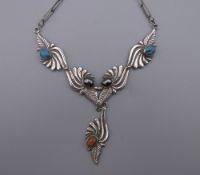 A vintage 925 silver Navajo necklace of leaf design with turquoise, coral and haematite inlay.