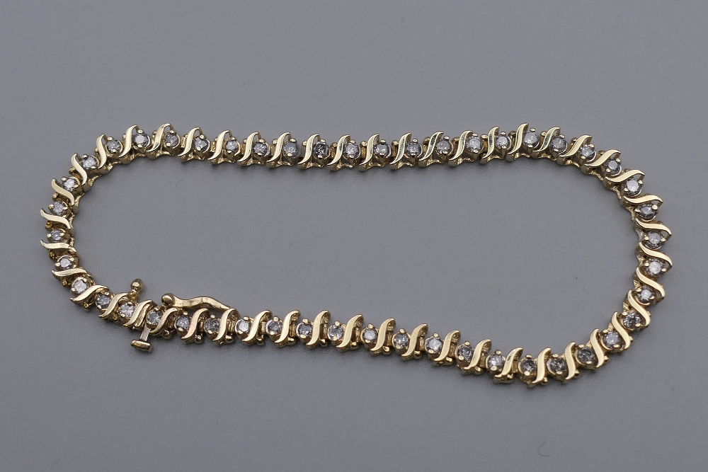 A 14 K gold diamond tennis bracelet with forty-seven diamonds, 0.
