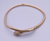 A 9 ct gold snake necklace. Approximately 40 cm long.