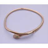 A 9 ct gold snake necklace. Approximately 40 cm long.