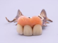 A gold denture. 5 cm wide. 10.3 grammes total weight.