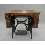 A Victorian sewing machine table including Singer sewing machine. 91.5 cm wide.