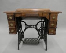 A Victorian sewing machine table including Singer sewing machine. 91.5 cm wide.