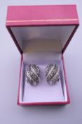 A pair of 14 ct white gold earrings set with white and yellow diamonds. 2 cm high.